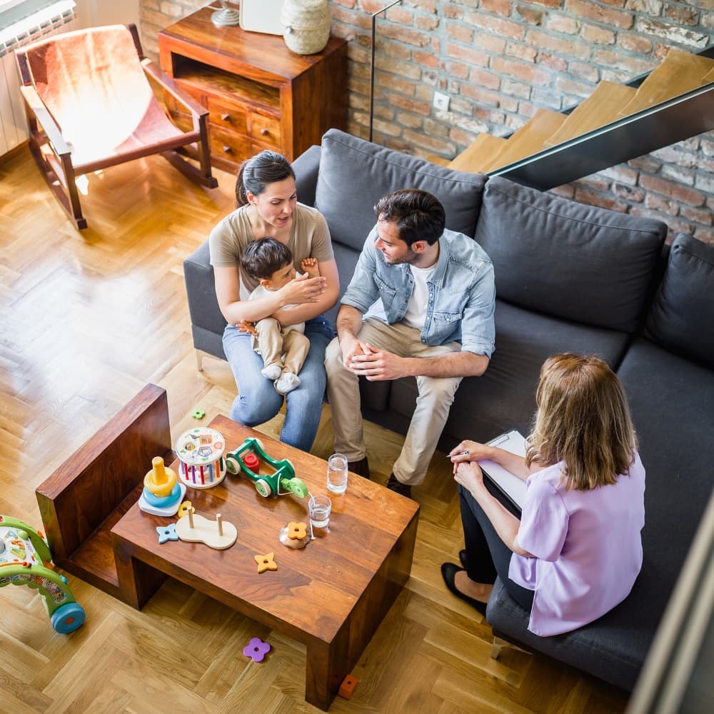 Aerial view of parents and child with family therapist