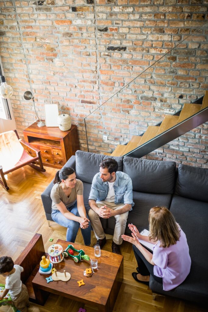 Family in a therapy session with child playing with toys