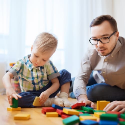 Father playing blocks with child