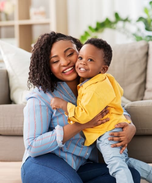Mother holding son with big smiles