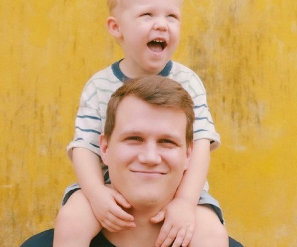 Dad carrying son on his shoulders